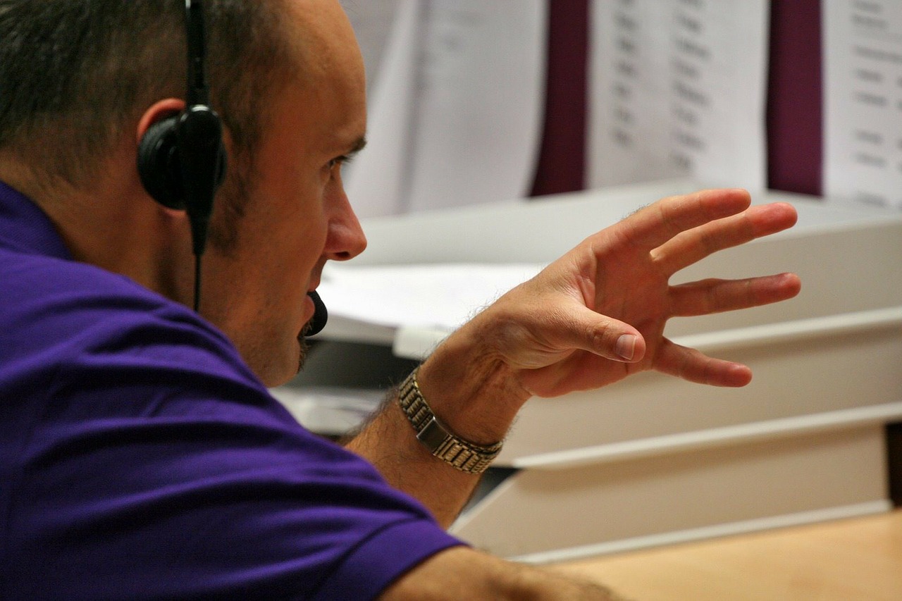 Man Talking to a customer on the phone. One reason you could ask employees to speak english inthe workplace.